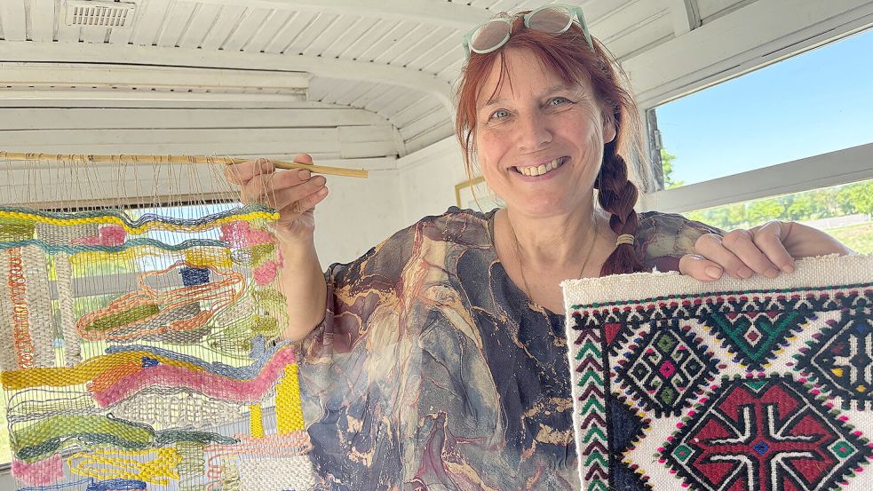 Karin Berends-Lüürßen mit Webarbeiten: links eine ihrer eigenen Arbeiten, recht eine Kelim-Weberei aus der Türkei. Foto: Janßen