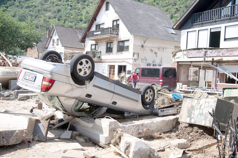 Ein von der Flut mitgerissenes Auto liegt in der Stadtmitte von Altenahr. Zahlreiche Häuser in dem Ort wurden komplett zerstört oder stark beschädigt. Foto: Boris Roessler/dpa
