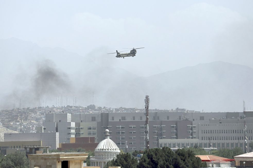 Rauch steigt aus Kabul auf: Taliban-Kämpfer sind am Sonntag in die Außenbezirke der afghanischen Hauptstadt eingedrungen. Ein Hubschrauber der USA landen bei der Botschaft und fliegen Menschen aus. Foto: Rahmat Gul/AP/dpa