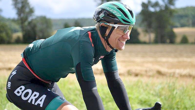 Pascal Ackermann vom Team Bora-Hansgrohe sitzt lächelnd auf dem Rad. Foto: Bernd Thissen/dpa