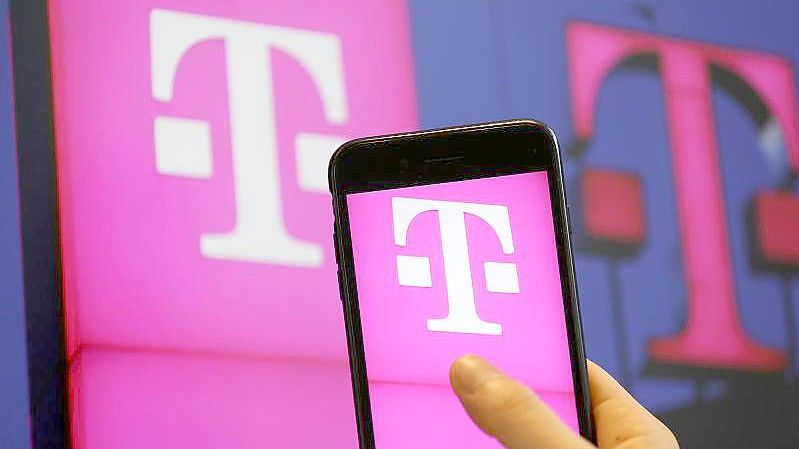 Das Logo der Deutschen Telekom ist auf dem Bildschirm eines iPhones zu sehen. Foto: Oliver Berg/dpa