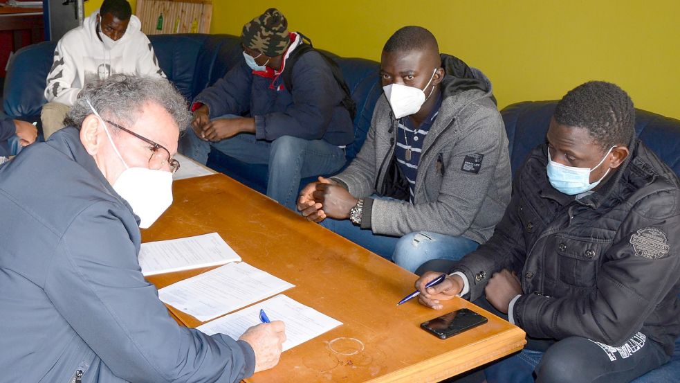 Reiner Gläßgen ging den Impffragebogen mit den französisch sprechenden Afrikanern durch. Foto: Karin Eden