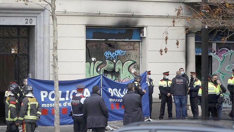 Polizeibeamte in der Nähe des Gebäudes in Barcelona, in dem ein Brand mit Todesopfern ausgebrochen ist. Foto: Kike Rincón/EUROPA PRESS/dpa