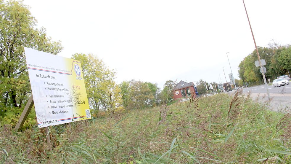 Dieses Foto stammt aus dem Jahr 2019. Damals hatte es in unserer Zeitung folgende Bildunterschrift: „Eigentlich sollte hier schon gebaut werden: Auf einem Gelände an der Petkumer Straße soll das neue Gebäude des RKSH entstehen. Ein Schild weist schon seit Jahren darauf hin.“ Der Bau hat immer noch nicht begonnen. Foto: Alberts/Archiv