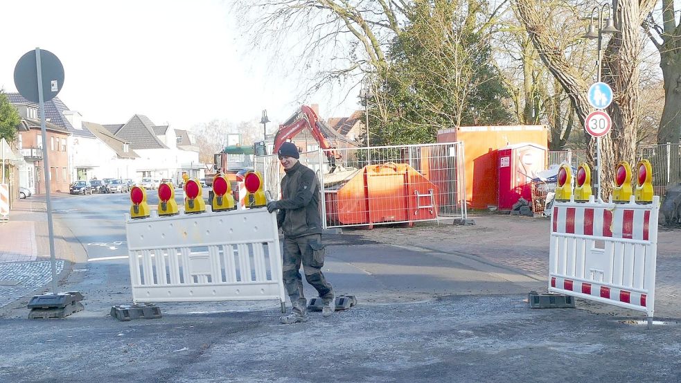 Bauleiter Lukas Federowicz räumt die Absperrungen an der Kreuzung „Kirchstraße/Meeschenstraße“ beiseite. Damit ist die Durchfahrt durch die Friesoyther Innenstadt bis zum Beginn der Bauarbeiten am Hansaplatz wieder möglich. Foto: Stix