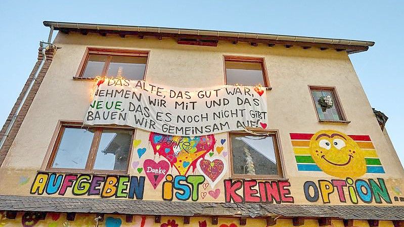 "Aufgeben ist keine Option“, steht auf der Fassade eines von der Flut zerstörten Hauses in Dernau. Foto: Thomas Frey/dpa