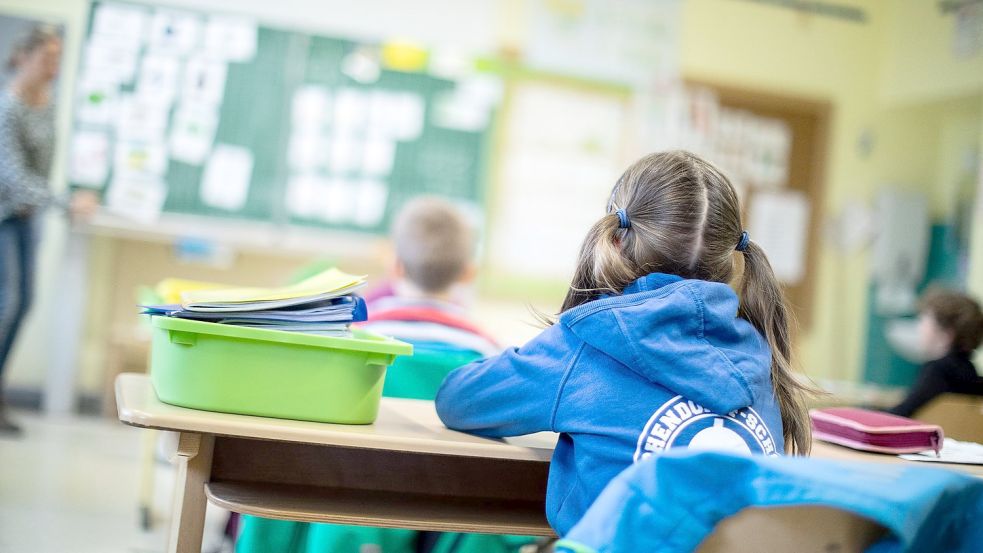 Schülerinnen und Schüler einer Grundschule sitzen in ihrem Klassenraum. Foto: Marcel Kusch/dpa