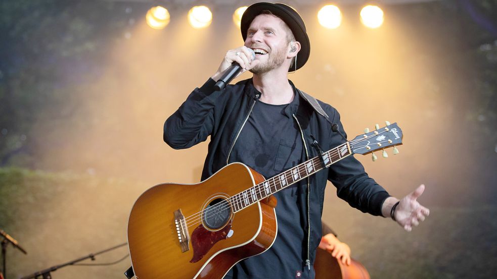 Johannes Oerding, Popsänger und Songwriter, steht bei einem Konzert auf der Open Air Bühne im Stadtpark in Hamburg. Am 27. Juli tritt er auf Norderney auf. Foto: Christian Charisius/dpa