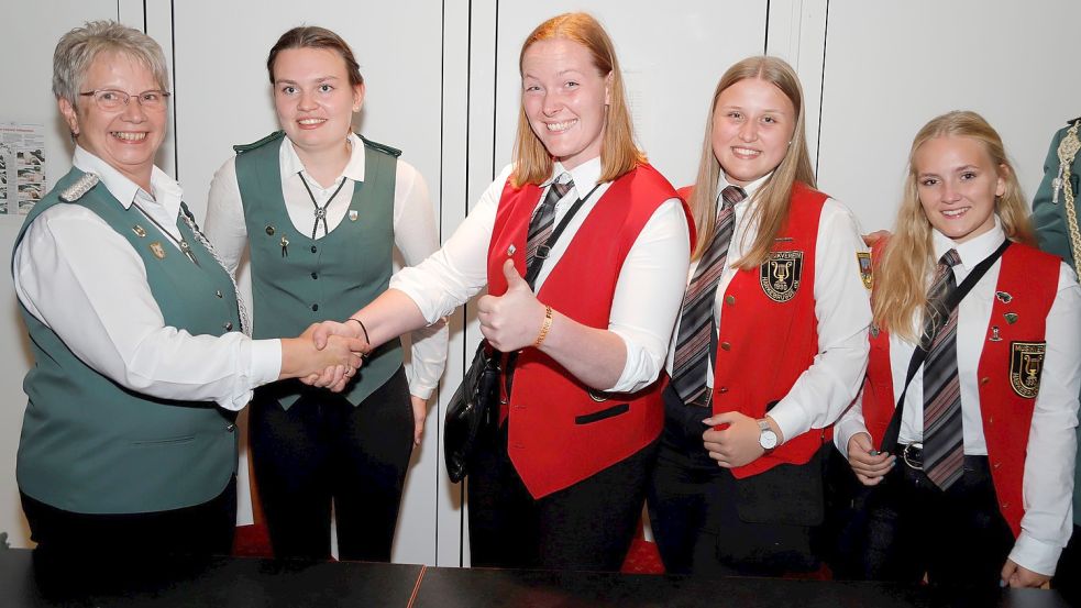 Daumen hoch zeigt die neue Königin des Schützenvereins Harkebrügge, Eva-Maria Oeltjenbruns (Mitte). Vorsitzende Heidi Eilers gratuliert ihr zur Königswürde. Zum Thron gehören außerdem Tomke Müller, Ella-Marie Cordes und Hannah Pacholke. Foto: Passmann