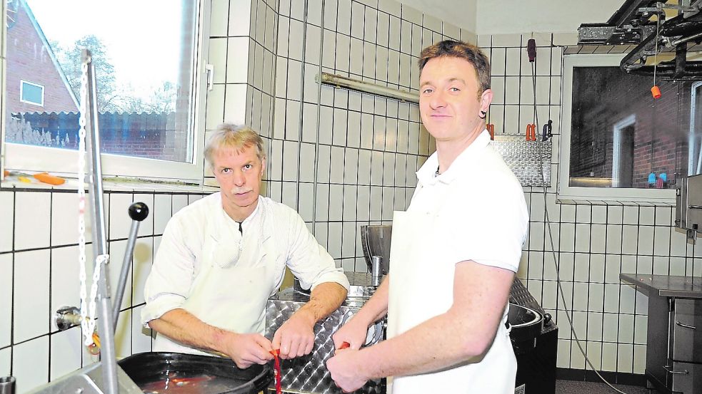 Noch arbeiten Jan Jansen (links) und Uwe Böckmann wie hier beim Wurstmachen Hand in Hand. Doch im Alter von 62 Jahren liebäugelt der zurzeit einzige Geselle in der Fleischerei mit dem Ruhestand. Foto: Schade