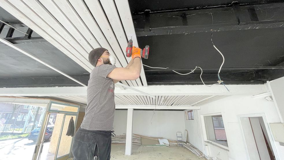 Ali Remmo montierte diese Woche die Holzvertäfelung der Decke in dem Geschäftsraum ab. Foto: Janßen