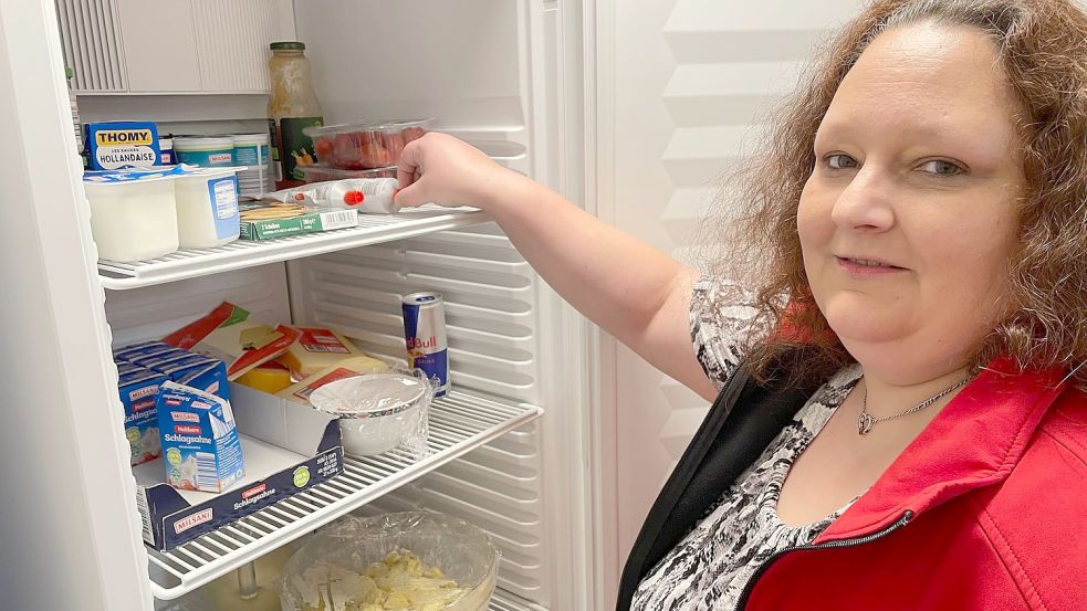 Da ist noch viel Luft drin: Stromsparhelferin Melanie Wegener am Kühlschrank des AKSR in Ihrhove. „Ein voller Kühlschrank verbraucht weniger Energie als ein leerer“, sagt sie. Foto: Janßen