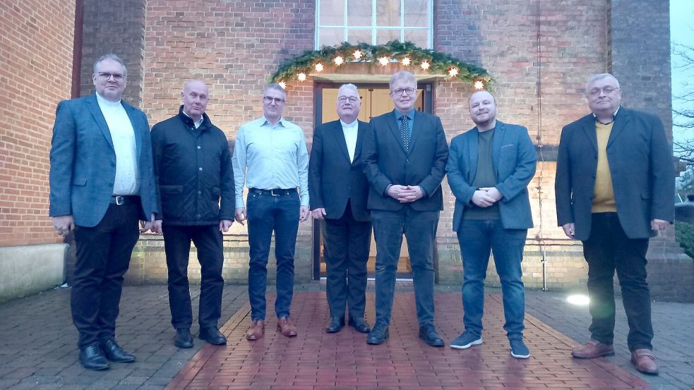 Vor der Hoffnungskirche demonstrieren (von links) Superintendent Thomas Kersten, die Pastoren Hartmut Kutsche, Frerich Dreesch-Rosendahl und Martin Sundermann, Dr. Bernhard Groyen, Hajo Kromminga und Walfried Pofalla Einigkeit. Fotos: Scherzer