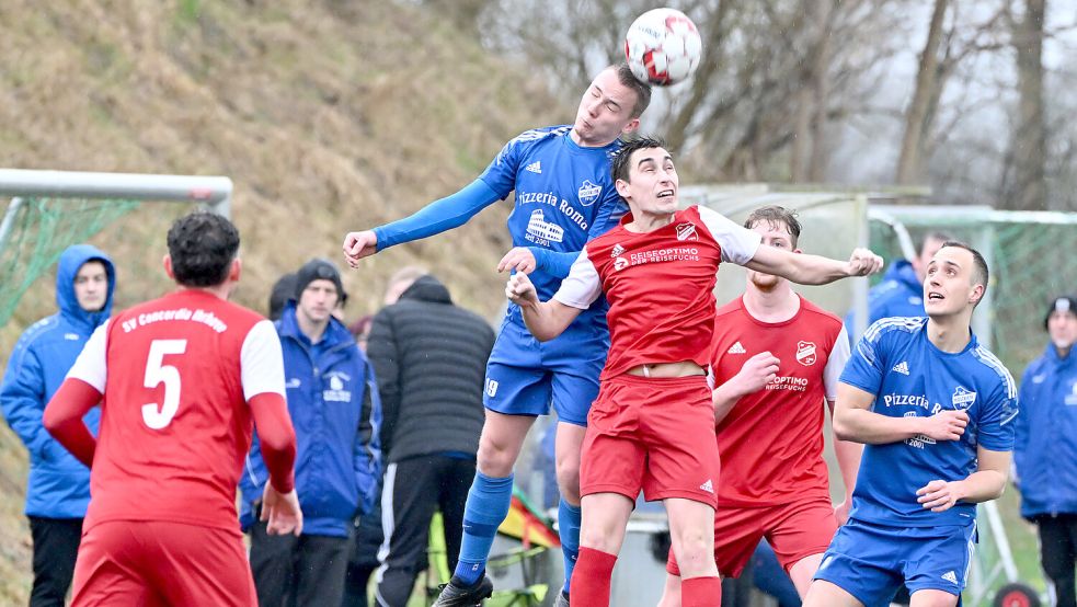 Der TuS Holtriem (blaue Trikots) steht nach dem Sieg gegen Ihrhove (rote Trikots) ganz oben in der Tabelle der Fußball-Ostfrieslandliga. Fotos: Doden, Blomberg