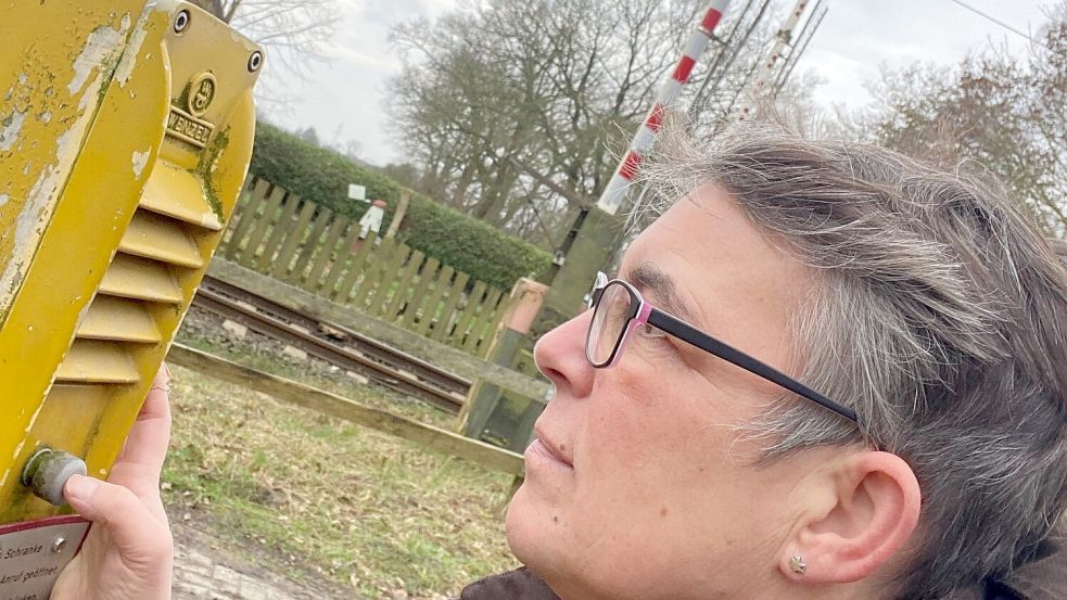 Damit sich im Hammrich in Logabirum die Schranken am Bahnübergang heben, muss man per Knopfdruck beim Schrankenwärter anrufen. Die Gegensprechanlagen gibt’s übrigens in zwei Höhen: für Fußgänger und für Treckerfahrer. Foto: Hanz