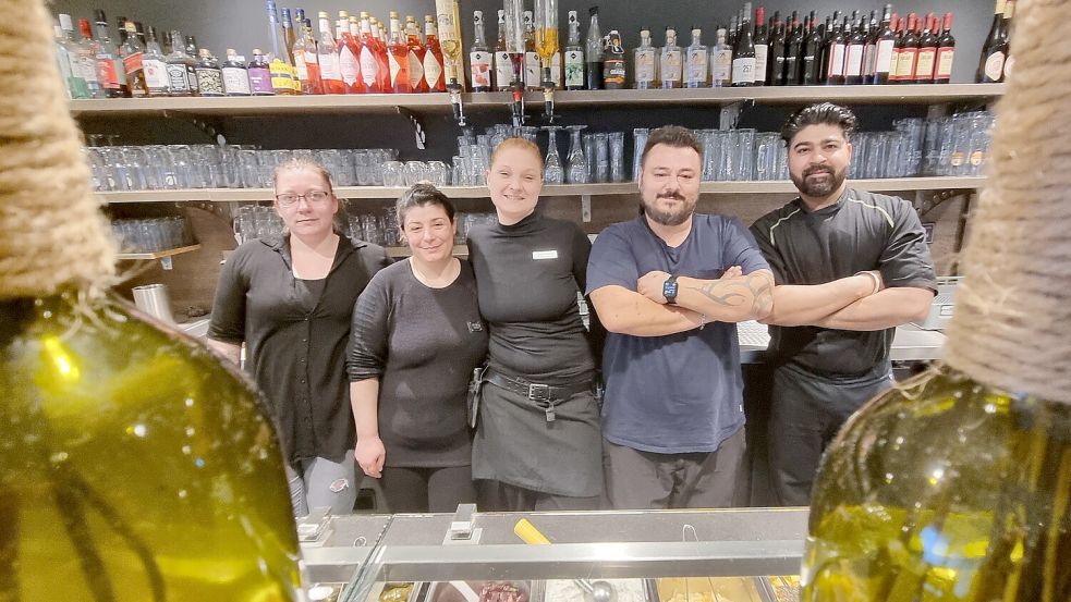 Stefanos Mokas (Zweiter von rechts) und sein Team – (von links) Mary Link (Service), Kozeta Bilbili (Köchin), Silke Meyer (Service) und Kumar Sandeeb (Koch) – bewirten die Gäste in der Greek Taverne. Foto: Bothe