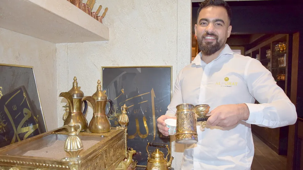 Mustafa Al Khalif schenkt einen heißen, mit Kardamom gewürzten Mokka in ein Becherchen. Die Kaffeekanne steht auf heißem Sand. Foto: Zuidema