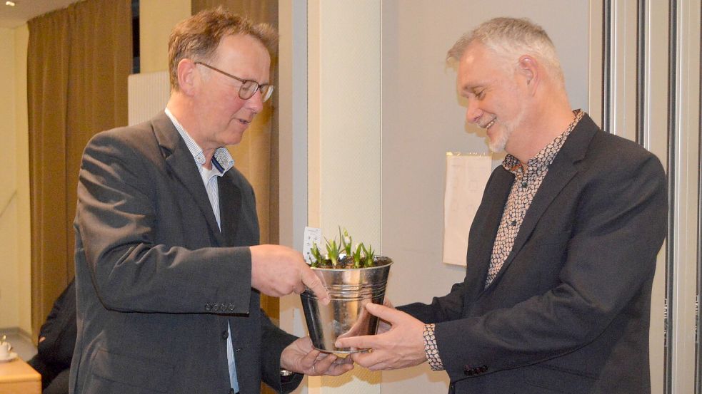 Norbert Pieper (links), Ortsvorsteher von Langholt-Ost, bedankte sich beim Ostrhauderfehner Bürgermeister Günter Harders mit einem Blumengeschenk für dessen Vortrag. Fotos: Weers