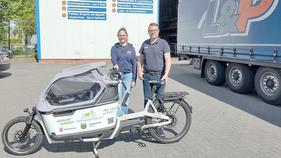 Das neue Elektro-Lastenrad „Focko“ kann kostenfrei bei der Firma Lücht & Palm in Naukamperfehn ausgeliehen werden. Lina Keiser und Volker Peters haben es vom Verein Ostfriesen-Fiets entgegen genommen. Foto: Samtgemeinde Hesel