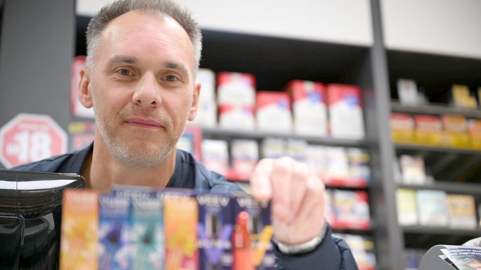 Er verkauft sowohl klassische Zigaretten als auch E-Zigaretten: der Düsseldorfer Tabakwaren-Geschäftsinhaber Sebastian Jähn. Foto: Wolf von Dewitz/dpa