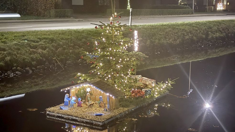Anwohner des Rajens haben diese schwimmende Krippe mit Weihnachtsbaum und Geschenkpaketen mittig auf dem Kanal platziert. Foto: Carsten Ammermann