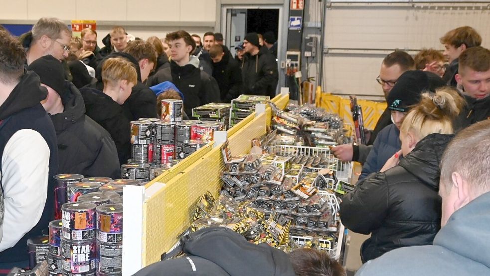 Schon weit vor Mitternacht bildete sich vor dem Handelskontor eine lange Schlange an Menschen, die sich möglichst früh ihre Feuerwerksutensilien wie Batterien, Raketen und Böller sichern wollten. Um 0.01 Uhr öffneten sich dann die Türen. Fotos: Holger Weers