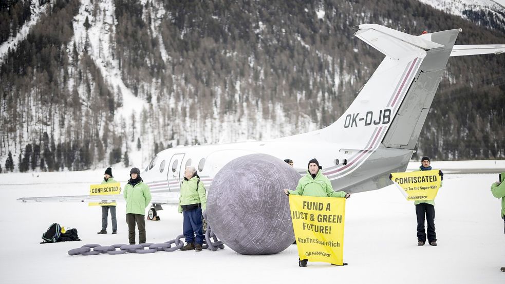 Im vergangenen Jahr hat Greenpeace in Davos gegen Privatflüge demonstriert. (Archivbild) Foto: Gian Ehrenzeller/KEYSTONE/dpa