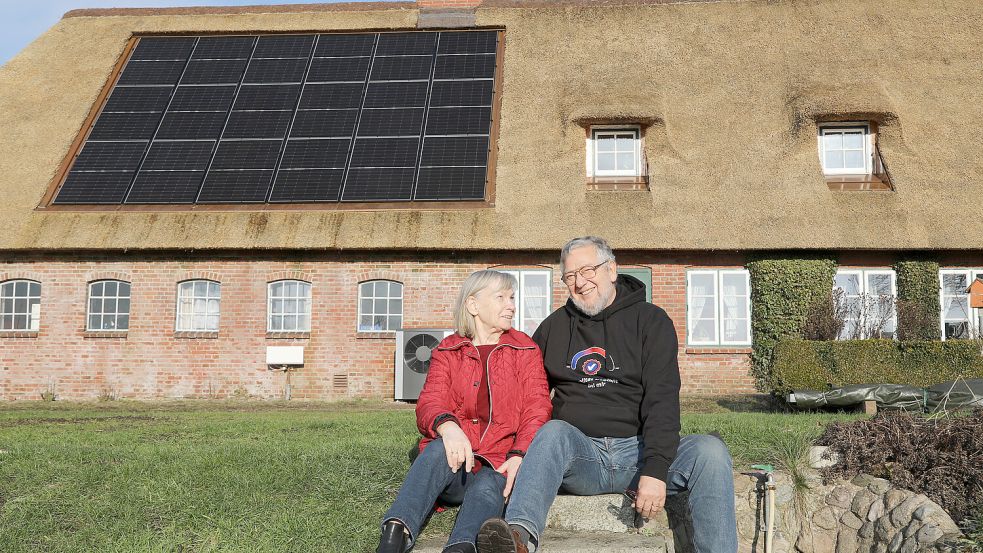 Irmtraud und Peter Kutzbach vor ihrem Reetdachhaus in Almdorf, das nun eine PV-Anlage hat. Foto: Karina Dreyer