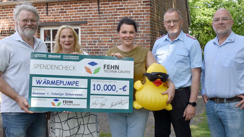Hinrich Heselmeyer (von links) und Jutta Kramer vom Heimatverein Overledingerland übergaben den Entenrennen-Hauptpreis an Kim Jahn aus Ostrhauderfehn. Sie hat eine Wärmepumpe im Wert von 10.000 Euro der Firma Natelberg gewonnen. Bei der Preisübergabe dabei waren auch Westrhauderfehns Ortsbrandmeister Ludger Böning und Natelberg-Marketing-Mitarbeiter Oliver Gerken. Foto: Henrik Zein