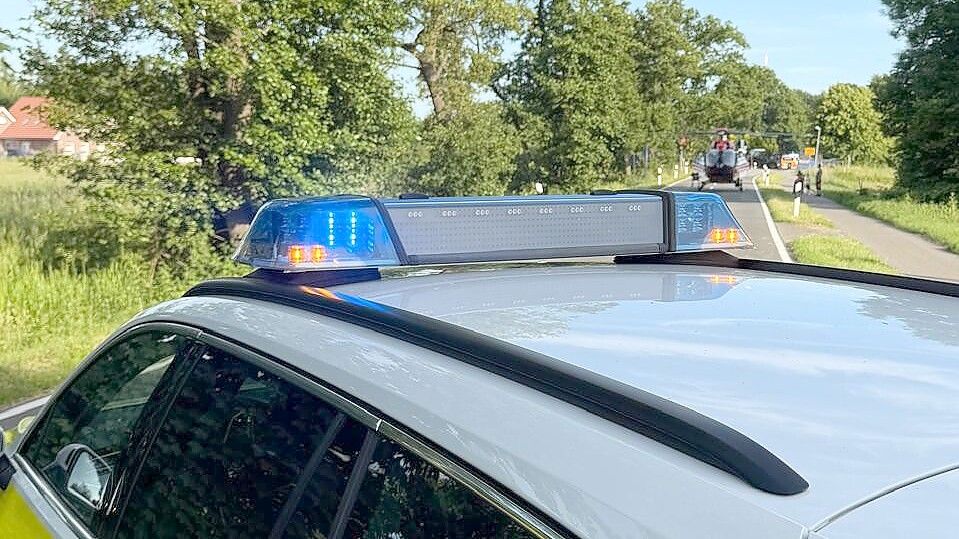 Die Polizei hat die Langholter Straße in Ostrhauderfehn gesperrt. Zwischenzeitlich ist ein Rettungshubschrauber (im Hintergrund) gelandet. Foto: Horst Kruse