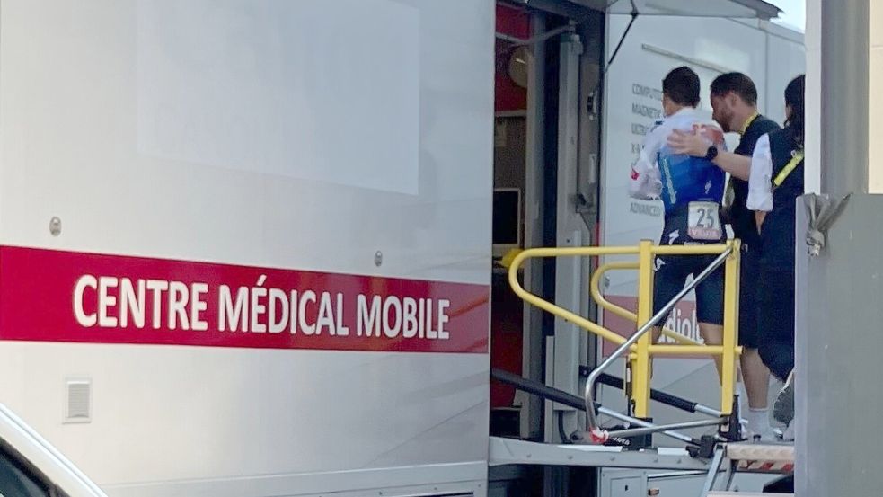 Florian Lipowitz (l) betritt den Medical Truck der Tour de France. Foto: Stefan Tabeling