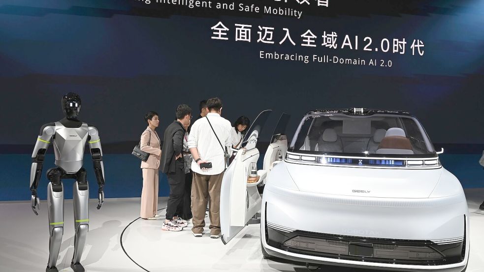 Hier präsentiert Geely ein Auto samt humanoidem Roboter auf einer Automesse in Peking. Nun wagt die Firma den Sprung nach Spanien, um dort Autos zu bauen. Foto: Johannes Neudecker/dpa