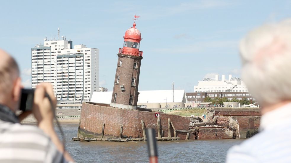 Ein Opfer der Holzbohrmuschel: Holzexperte Dr. Johann Müller (links) und seine Frau reisten im August 2022 zum abgesackten Moleturm in Bremerhaven. Der Holzunterbau der Nordmole war völlig zerstört. Foto: Markus Hibbeler/dpa