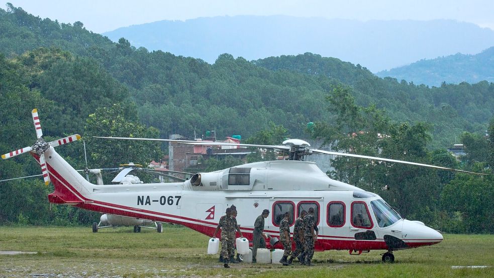 Soldaten der nepalesischen Armee betanken einen Hubschrauber, bevor dieser zu einem Rettungseinsatz nach den Sturzfluten abhebt. Foto: Niranjan Shrestha