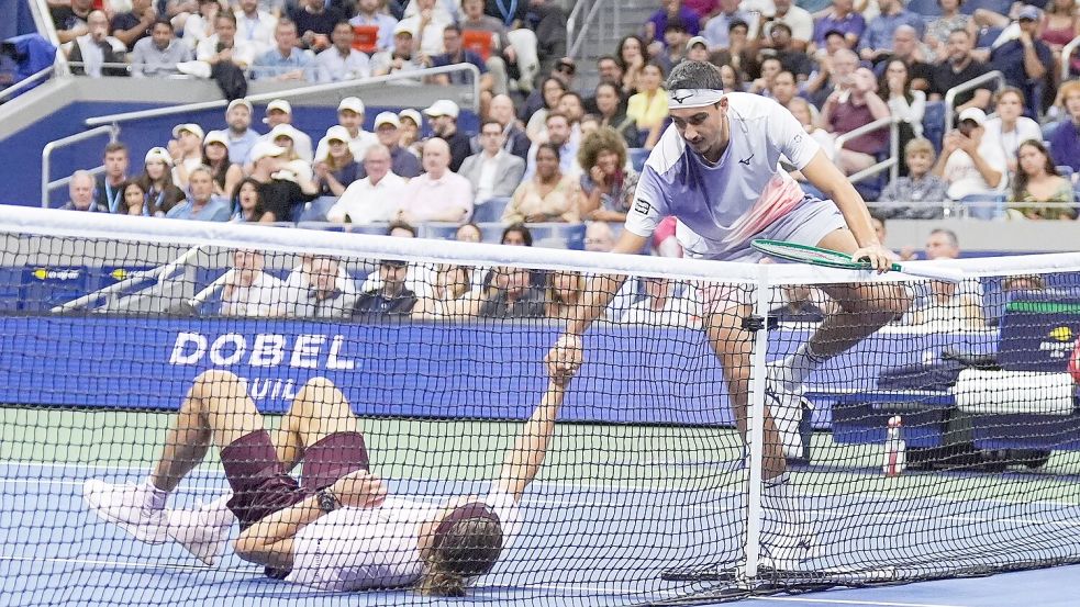 Lorenzo Sonego (r) hilft Zverev nach einem Strauchler wieder auf die Beine. Foto: Frank Franklin II/AP/dpa