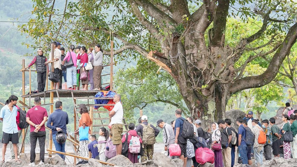 Menschen im Katastrophengebiet in Nepal warten darauf, in eine provisorische Seilbahn besteigen zu können. Foto: Rajesh Kumar Singh